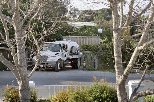  Ricardo DeAratanha / Los Angeles Times - A chemical services truck leaves Bob Dylan’s property after emptying a portable toilet hidden behind a storage container in this picture.
